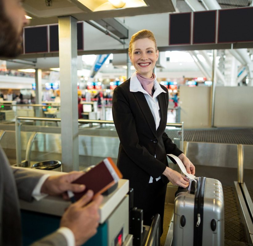 airline-check-attendant-sticking-tag-luggage-commuter (1)
