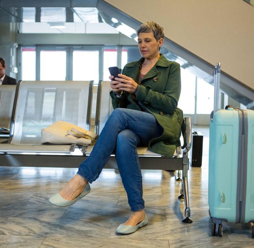 female-passenger-using-her-mobile-phone-waiting-area (1) female-passenger-using-her-mobile-phone-waiting-area (1)